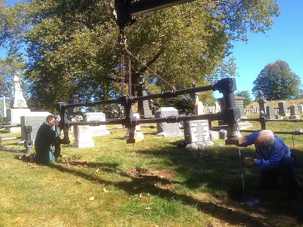 Alex and Dom lowering a section of repaired fence into place.