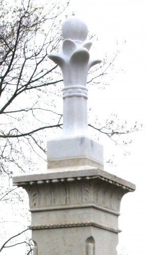 The new marble top, in place. With exposure to the elements, it should darken a bit, matching the original marble better. Note the decorative horizontal line of baseballs just above the bat handles, another of the baseball images on the monument. 
