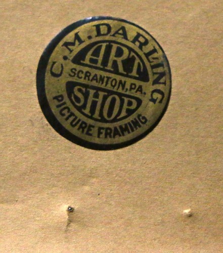The picture framer's label on the back of the framed print.