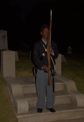 One of the re-enactors who stood in the dark along the way.