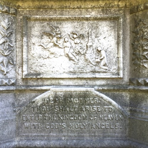 One of the angel scenes on the monument--it is very skillfully carved and shows an unusual cemetery scene, with an obelisk and angels at the moment of resurrection.