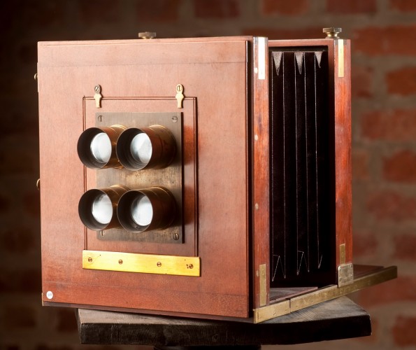 A 19th-century 4 lens carte de visite camera. Each of the lens would have had a lens cap covering it; removal of all of the caps simultaneously (attached with string or on a board) would have resulted in 4 identical negatives for printing en masse.