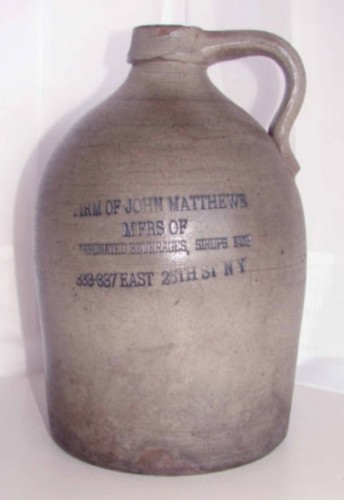 A stoneware crock with the label of the Matthews Company. These were used as containers for the various flavored syrups.
