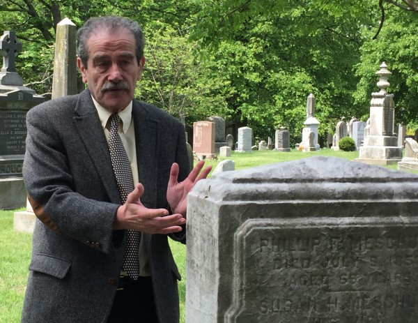 Major League Baseball's brilliant historian, John Thorne, at the grave of Louis Fenn Wadsworth. Wadsworth's name is carved on the side of the stone, where Thorne's hands are.