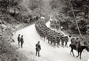 Men of the 307th Infantry Regiment regimental band, marching on a road near Famechon, France, 7 June 1918.