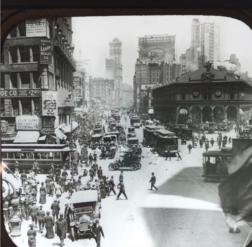 Herald Square, early in the 20th century. The Herald Building, headquarters of the New York Herald newspaper, is the dark, low building at right midground. The tall building in the distance up Broadway is the Times Building. The founders of both newspapers, James Gordon Bennett for the Herald and Henry Raymond for the Times, are interred at Green-Wood.