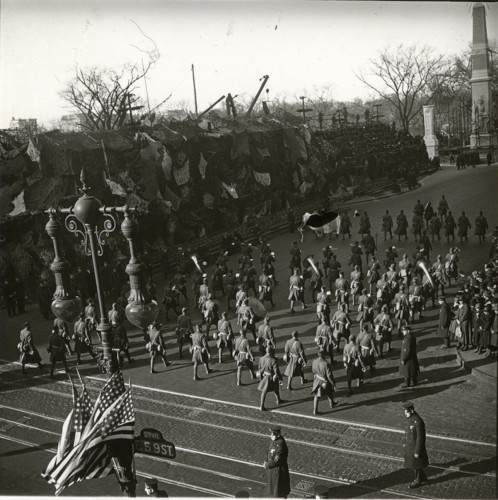Soldiers on parade. Note the street sign at right.