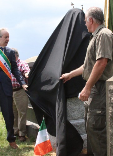 Left to right, Peter Mackay of the County Waterford Association, Jeff Richman of Green-Wood (partially hidden), and sculptor Michael Keropian, unveiling the Meagher Memorial.