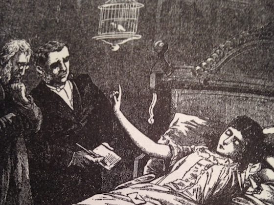 doctors talking with a woman in a bed