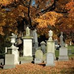 fall cemetery monuments in leaves