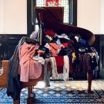 grand piano filled with clothing