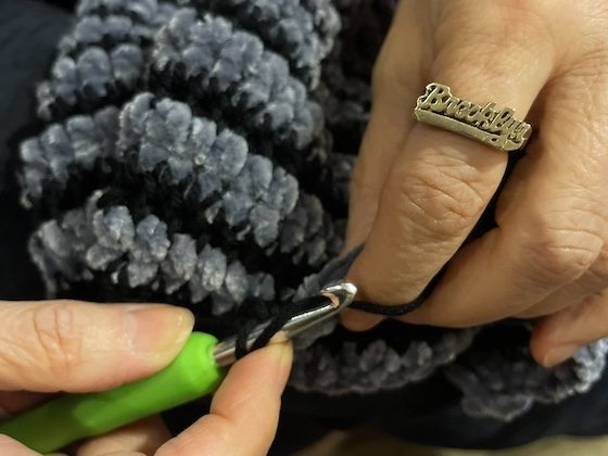 hands weaving with brooklyn ring