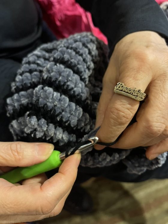hands weaving with brooklyn ring