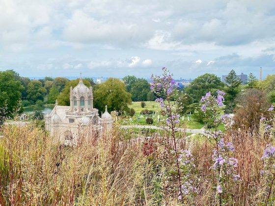 cemetery chapel with grasses and clouds