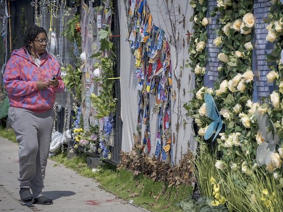 woman standing near memorial wall