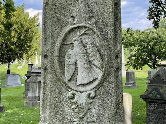 carved bird on grave monument