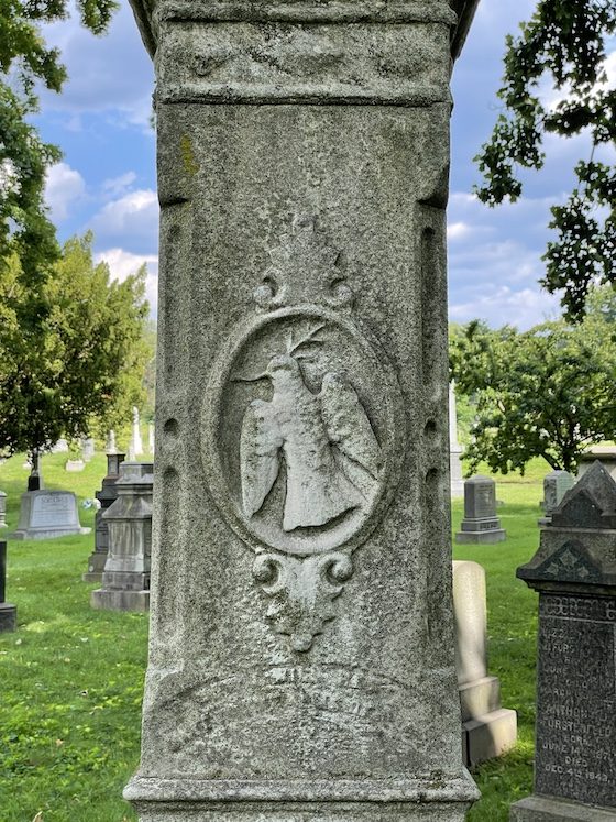 carved bird on grave monument